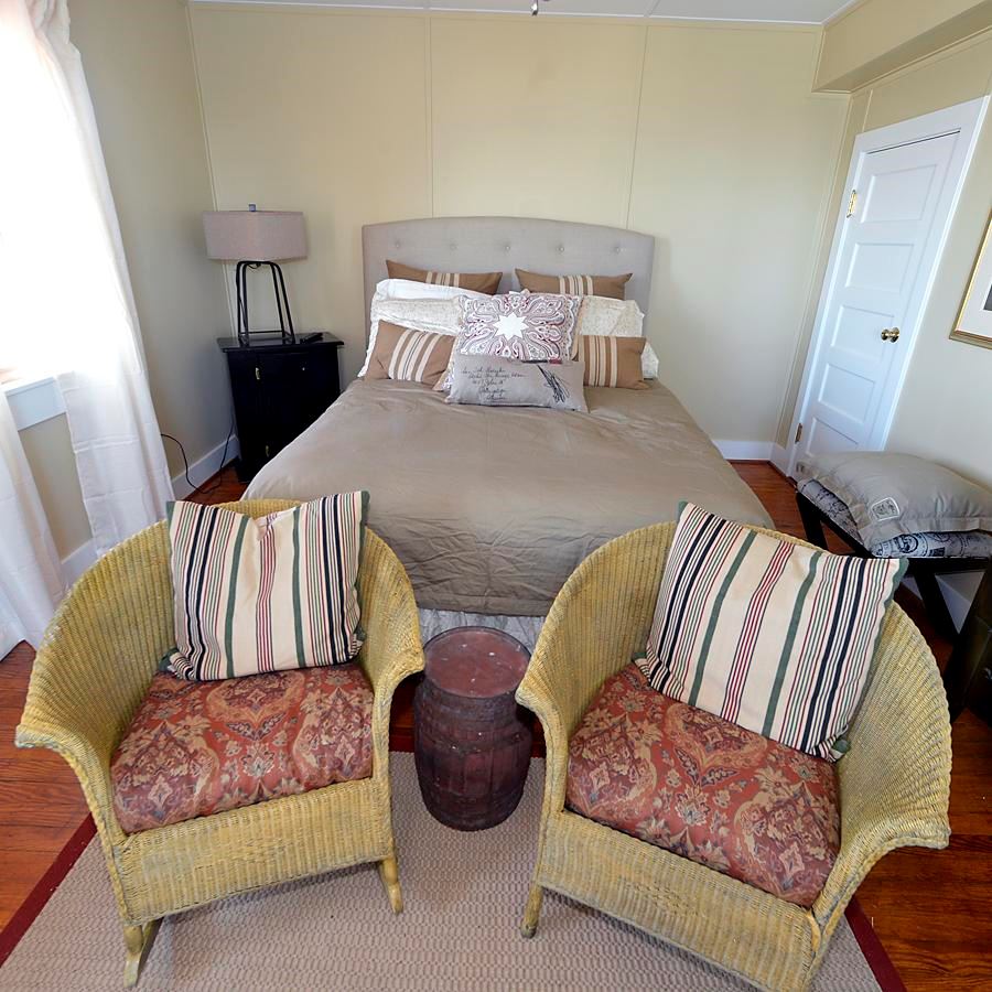 Bed and chairs at the Cove Point Lighthouse Keeper's Cottage