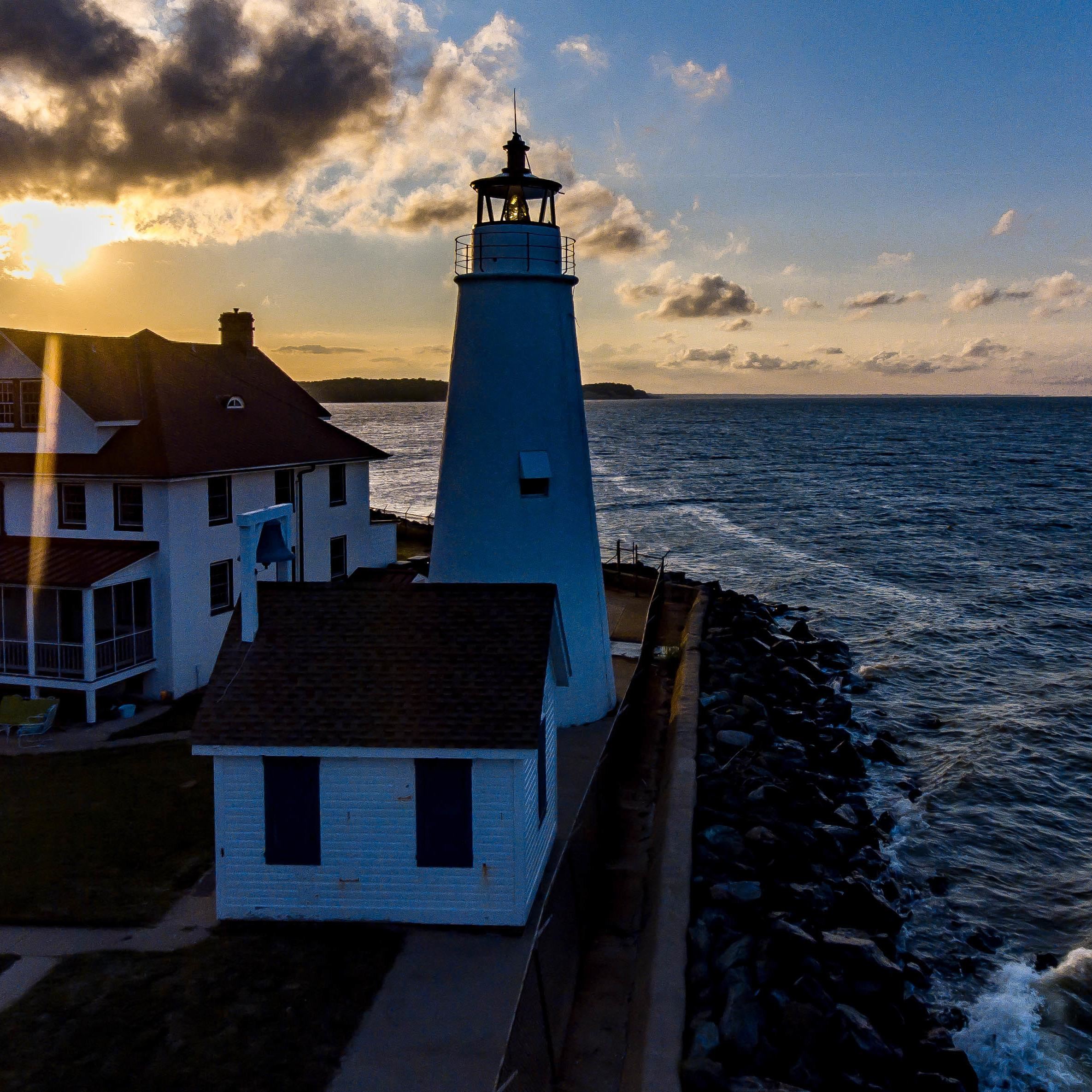Cove Point Lighthouse at sunset overlooking the water