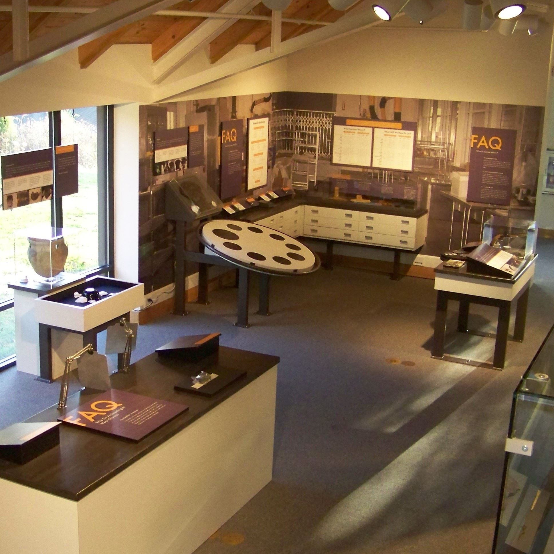 Aerial view of the exhibit in the museum, including FAQ signs and old artifacts