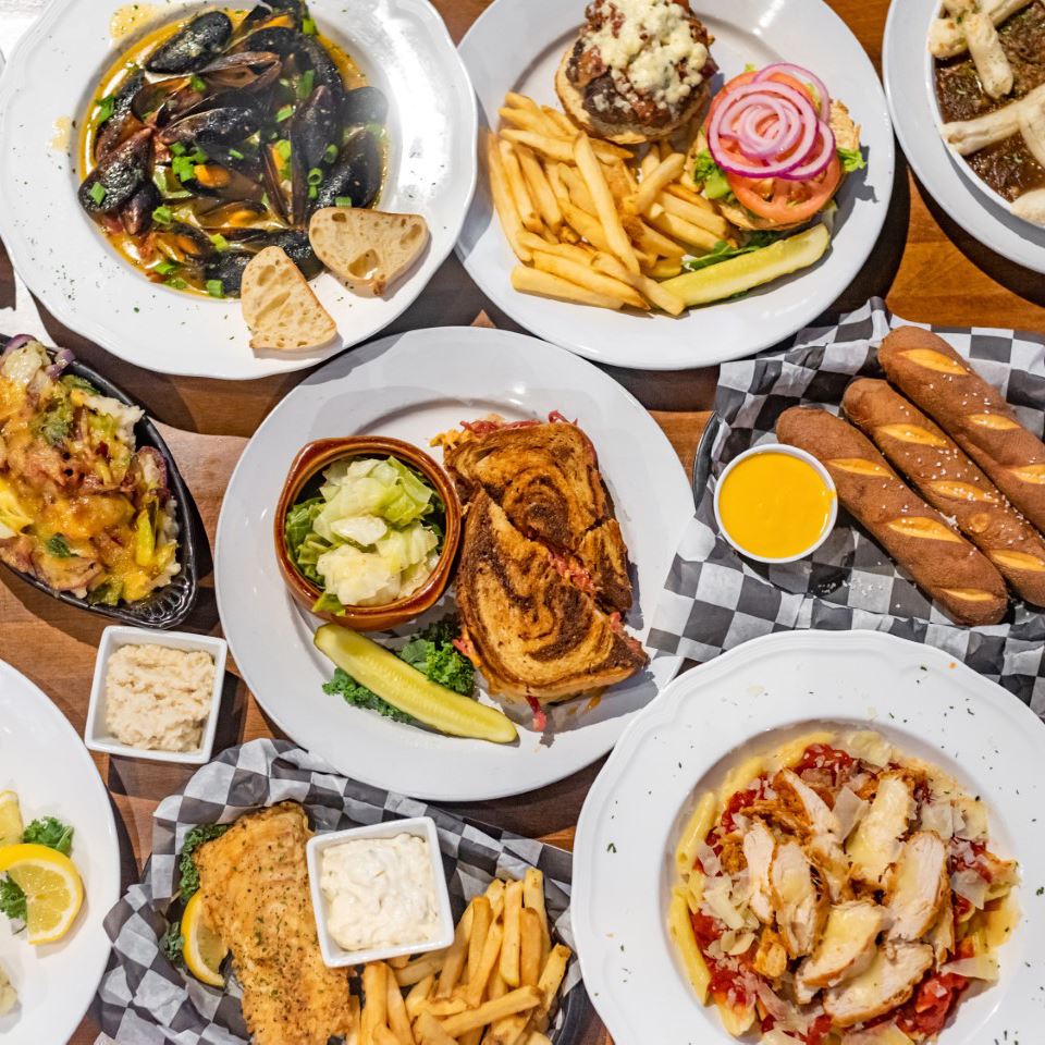 Buffet with fish and fries, sandwich, pasta, breadsticks with dipping sauce, and oysters