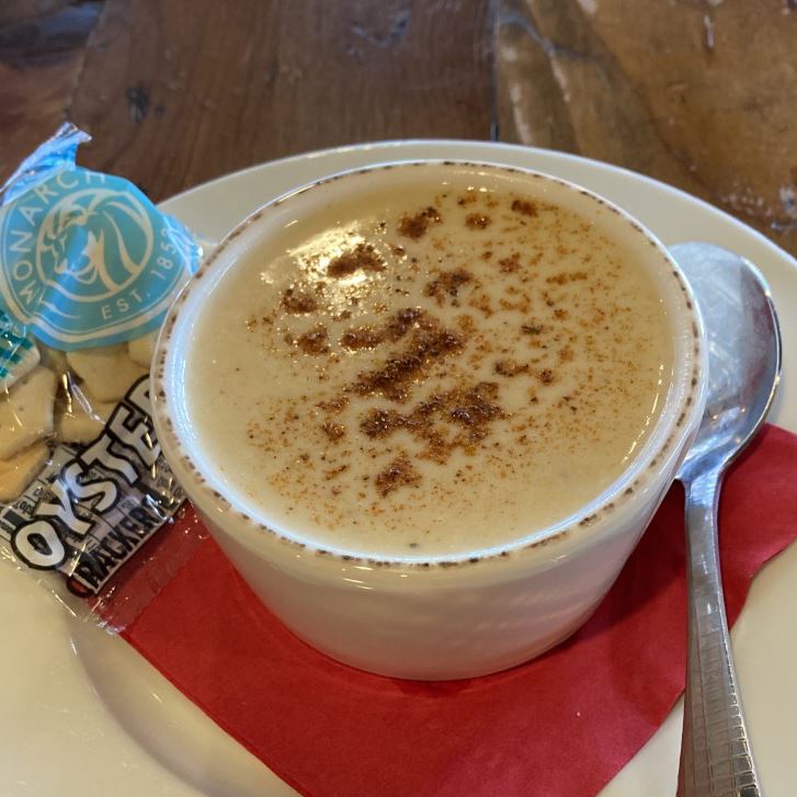 Crab soup with oyster crackers and a spoon