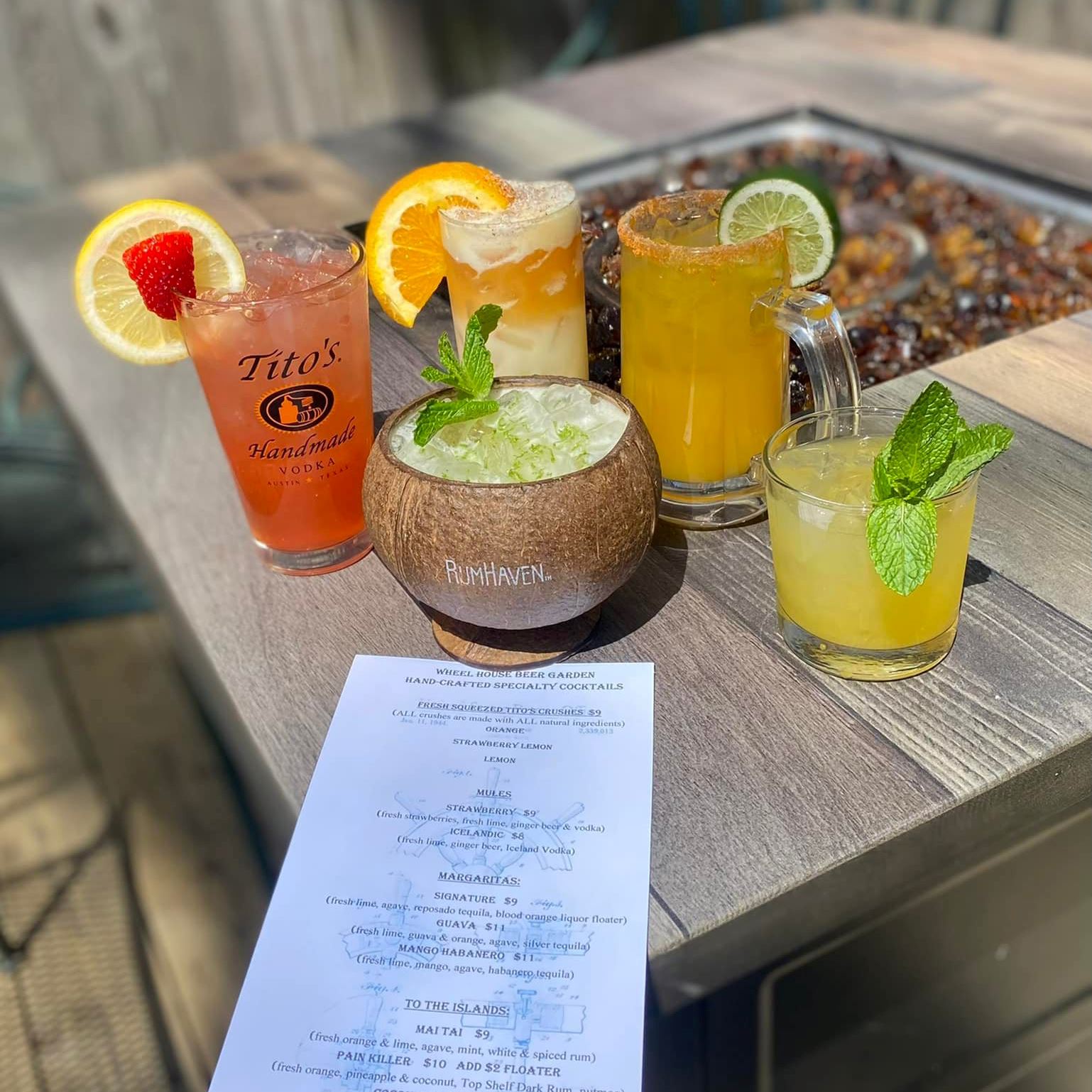 Cocktails and a menu on a fireplace table