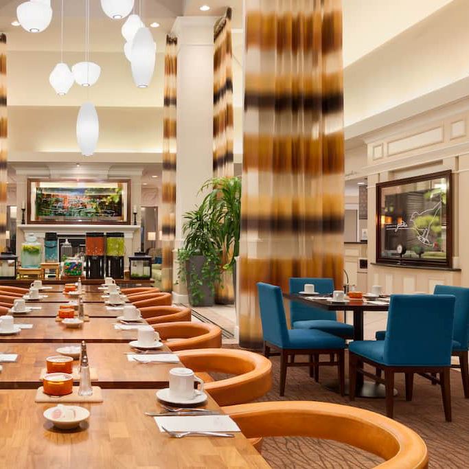 Dining area with blue and orange chairs and place settings