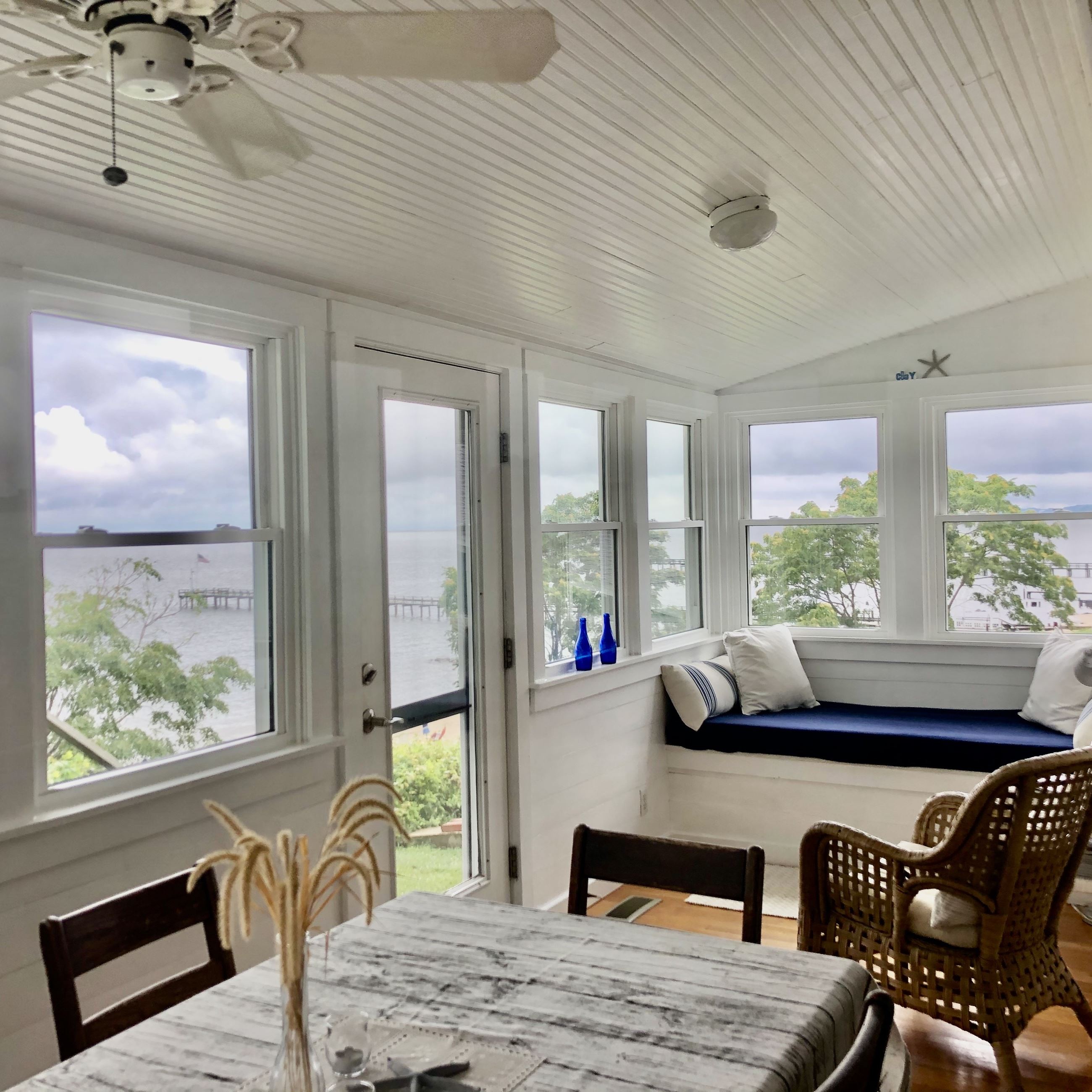 A guest room full of windows overlooking the water