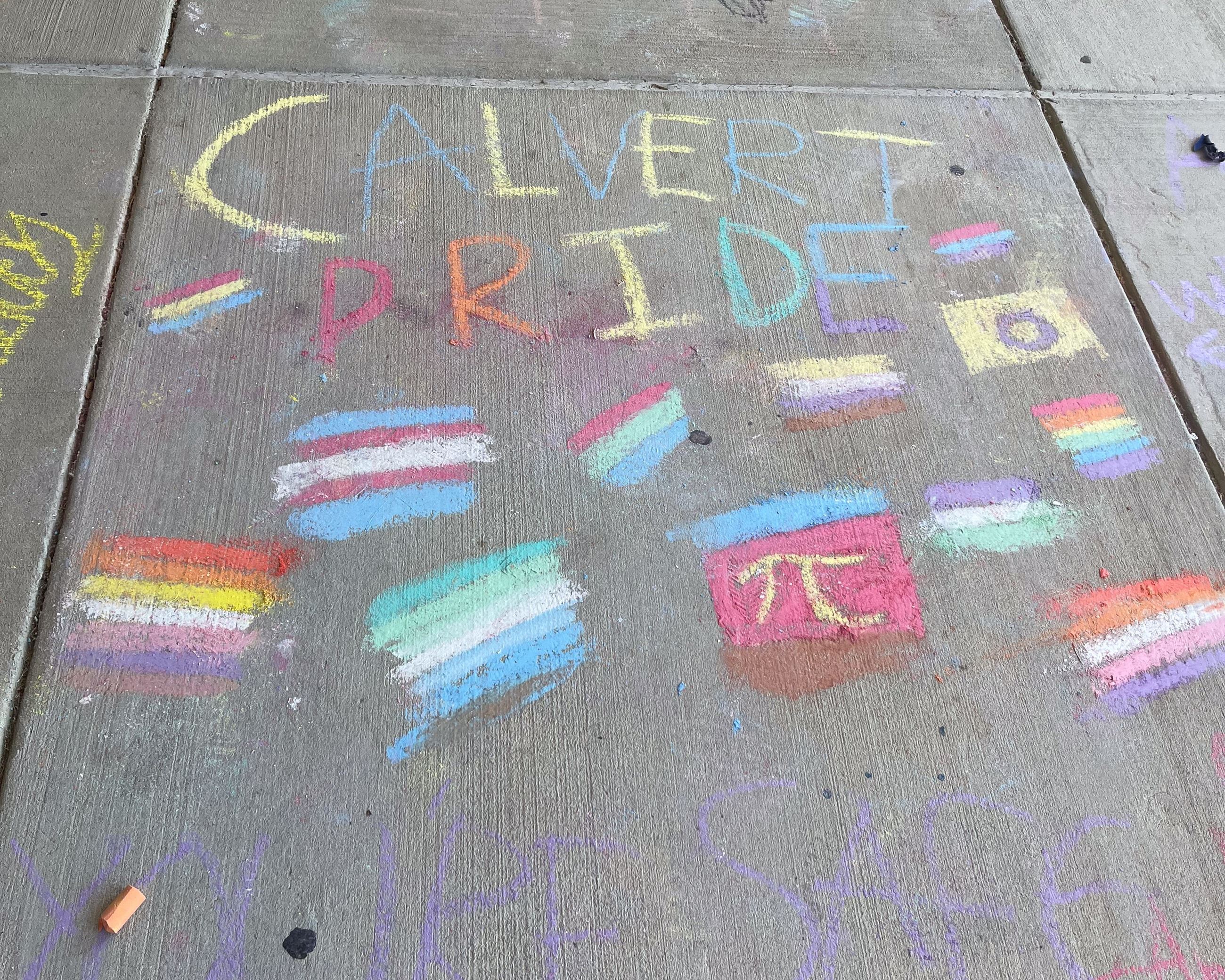 Many chalk art messages for positive mental health in front of Calvert High School.