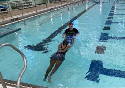 Instructor teaching swimming lesson
